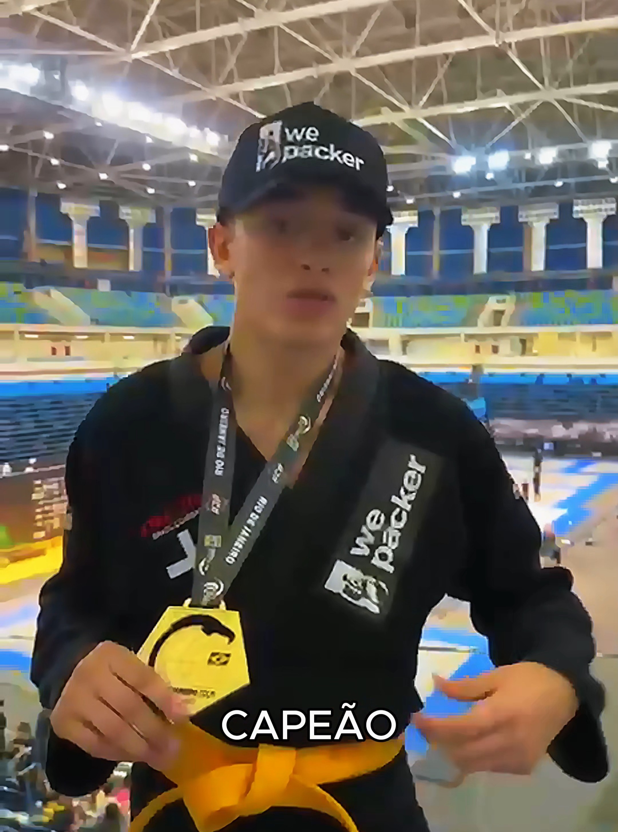 Álvaro Luís holding a jiu-jitsu medal